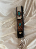 Tooled cowhide wristlet